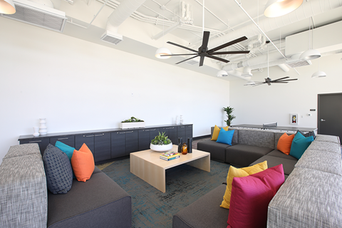 a living room with couches and colorful pillows